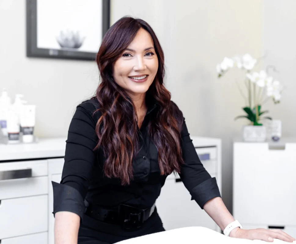 Terrie Absher Kochman, Licensed Medical Aesthetician using Omnilux LED mask for skincare results